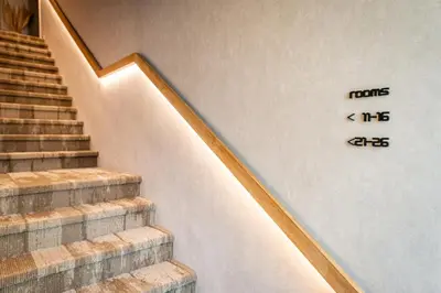 a set of stairs with a clock on the wall at Bloomhotel in Lochristi