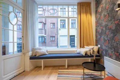a window seat in a room with a large window at SHWAY - The Red Monkey in Antwerp