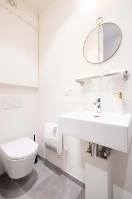 a white bathroom with a toilet and a sink at SHWAY - The Red Monkey in Antwerp
