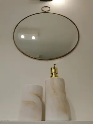 a mirror on top of a shelf with towels at SHWAY - The Blue Parrot in Antwerp