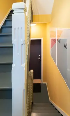 a hallway with stairs leading to a door at SHWAY - The Blue Parrot in Antwerp