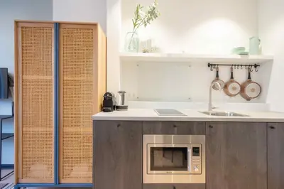 a kitchen with a counter with a microwave in it at SHWAY - The Light Blue Parrot in Antwerp
