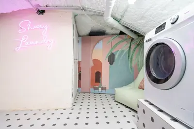 a laundry room with a washing machine in it at SHWAY - The Light Blue Parrot in Antwerp