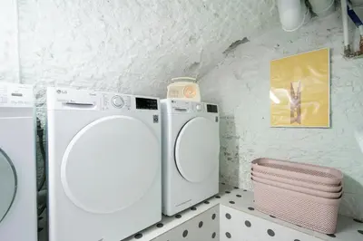 a white washer and dryer in a bathroom at SHWAY - The Light Blue Parrot in Antwerp