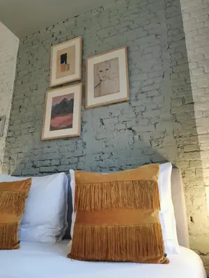 a bedroom with a bed with pictures on the wall at SHWAY - The Light Blue Parrot in Antwerp