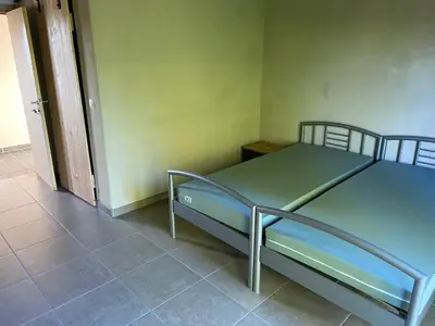 a hospital bed in a room with a doorway at De Kasseihoeve in Kalken