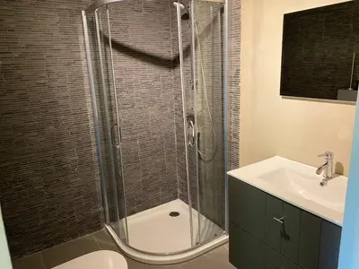 a bathroom with a shower and a toilet and a sink at De Kasseihoeve in Kalken