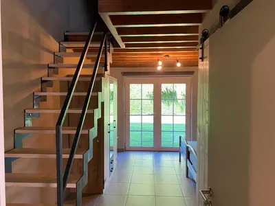 a hallway with stairs in a house at De Kasseihoeve in Kalken