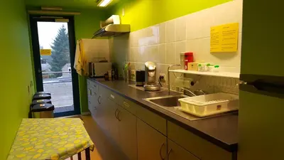 a kitchen with a sink and a counter top at Hotel Amethist in Ramsel