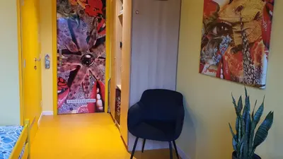 a black chair sitting in a hallway next to a door at Hotel Amethist in Ramsel