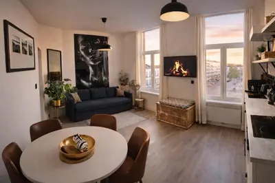 a living room with a table and a couch at Modern Cityflat at Theaterdistrict in Antwerp