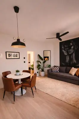 a living room with a table and a couch at Modern Cityflat at Theaterdistrict in Antwerp