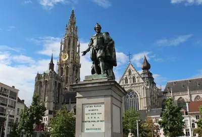 a statue in front of a building with a clock tower at Modern Cityflat at Theaterdistrict in Antwerp