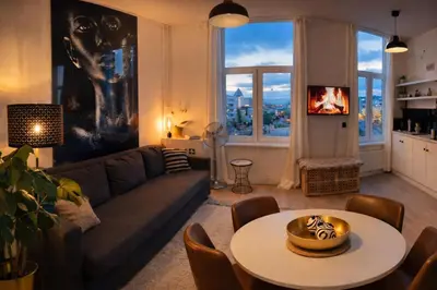 a living room with a couch and a table at Modern Cityflat at Theaterdistrict in Antwerp