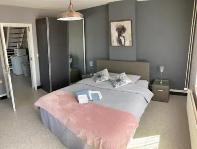 a bedroom with a large bed with two towels on it at B&B Den Boskant in Zandbergen
