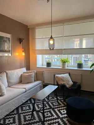 a living room with a couch and a table at Elma’s Place in Ghent