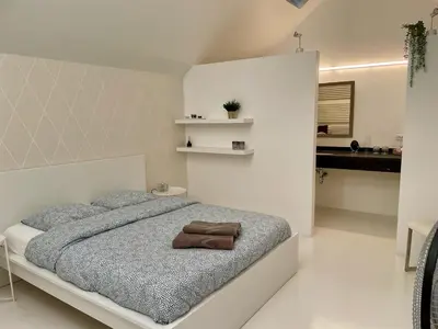 a bedroom with a bed with a towel on it at Luxurious villa during tomorrowland in Hemiksem