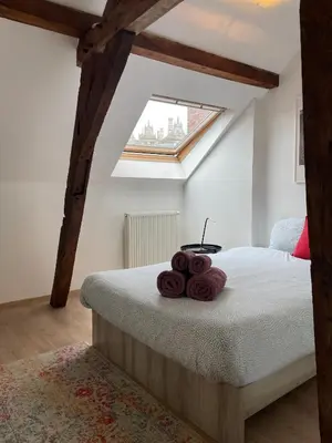 a bedroom with a bed with brown towels on it at Duplex Apartment in the Heart of Ghent with Fantastic Views in Ghent