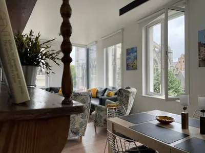 a living room with a table and a couch at Duplex Apartment in the Heart of Ghent with Fantastic Views in Ghent
