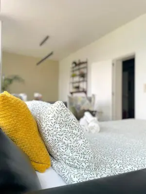 a bed with two pillows on top of it at Duplex Apartment in the Heart of Ghent with Fantastic Views in Ghent
