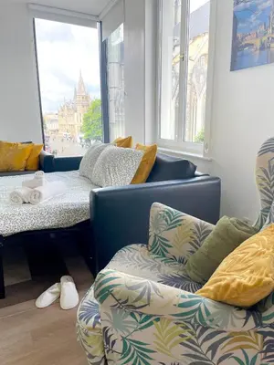 a room with a couch and a bed and a window at Duplex Apartment in the Heart of Ghent with Fantastic Views in Ghent