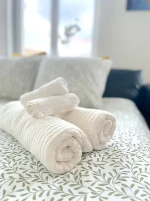 a pile of towels sitting on top of a bed at Duplex Apartment in the Heart of Ghent with Fantastic Views in Ghent