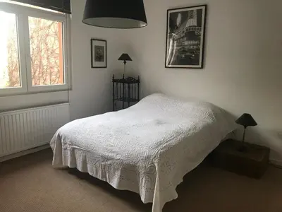 a bedroom with a white bed and a window at New apartment in Brussels house in Brussels