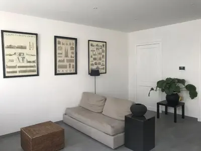 a living room with a couch and pictures on the wall at New apartment in Brussels house in Brussels