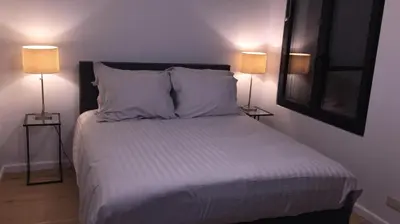 a bedroom with a bed with two lamps on both sides at Kloosterloft in Antwerp