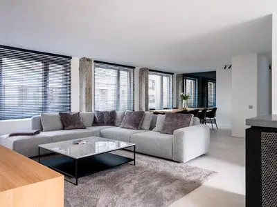 a living room with a couch and a table at Maison N in Ghent