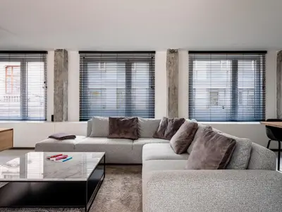 a living room with a couch and a coffee table at Maison N in Ghent