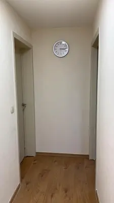 an empty room with a clock on a wall at Panda Bella in Zaventem
