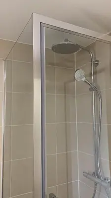 a shower with a shower head in a bathroom at Panda Bella in Zaventem