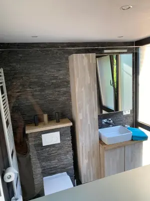 a bathroom with a sink and a mirror at Appartement met groot terras in Mortsel