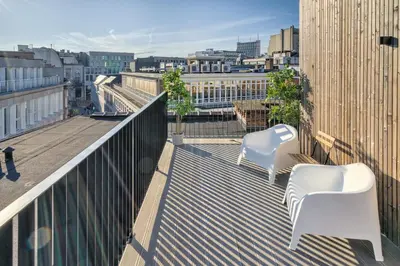 two white chairs sitting on top of a balcony at Apartment with Rooftop Terrace in the Heart of Antwerp in Antwerp