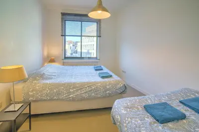 a bedroom with two beds and a window at Apartment with Rooftop Terrace in the Heart of Antwerp in Antwerp