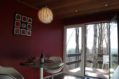 a dining room with a table and a window at Green Hill Apartment Overijse in Overijse