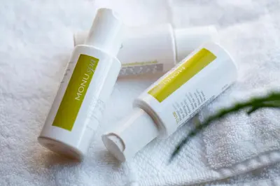 two tubes of sunscreen sitting on top of a towel at B&B Langeveldemolen in Merchtem