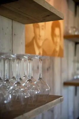 a row of wine glasses sitting on a shelf at B&B Langeveldemolen in Merchtem