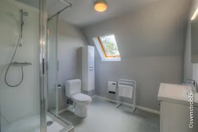 a bathroom with a shower and a toilet and a sink at JFK Hotel Zelzate - Gent in Zelzate