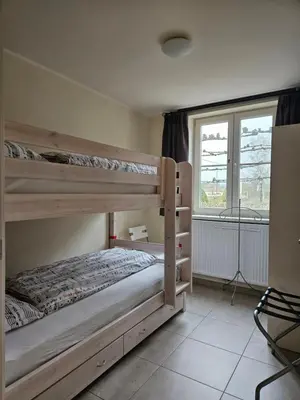 a bedroom with two bunk beds and a window at B&B OLEN in Olen