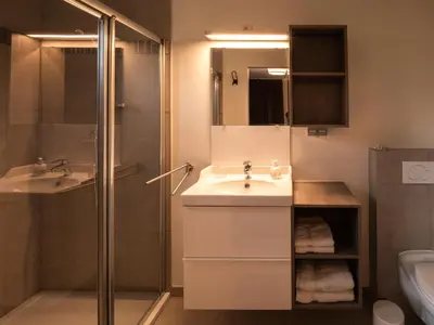 a bathroom with a sink and a shower at B&B OLEN in Olen