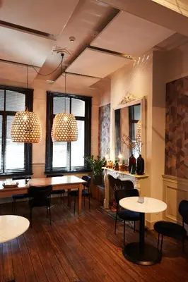 a dining room with tables and chairs and windows at B&B Toast Hoogstraten in Hoogstraten
