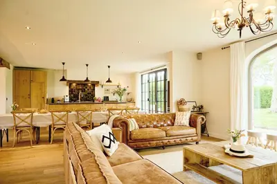 a living room with a couch and a table at Muntershof in Velzeke-Ruddershove