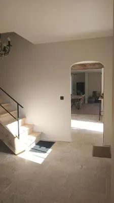 a room with stairs and a dining room with a table at Muntershof in Velzeke-Ruddershove