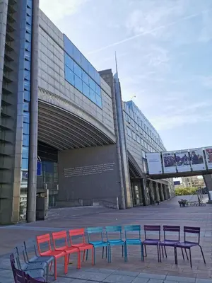 a group of tables and chairs in front of a building at Charming Europarlament Resedence in Brussels