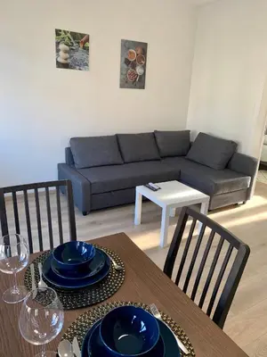a living room with a table and a couch at Charming Europarlament Resedence in Brussels