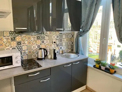 a kitchen with a sink and a microwave at Charming Europarlament Resedence in Brussels