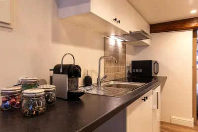 a kitchen with a sink and a counter top at B&B Steendam 66 in Ghent