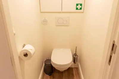 a small bathroom with a toilet and a toilet paper dispenser at B&B Steendam 66 in Ghent